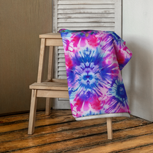 Load image into Gallery viewer, Tie-dye beach towel with cute pug print on table - folded on a bench or stool