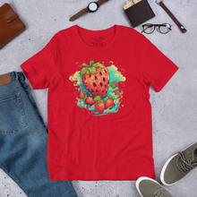 Load image into Gallery viewer, Model sporting the Berry Whirlwind Crimson Tee, embodying the spirit of adventure and freedom. Shirt laid out with geans shoes wallet glasses watch and date book laid out on a break