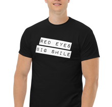 Load image into Gallery viewer, Model confidently sporting the black Covert Grin Tee, embodying the spirit of quiet rebellion and undercover style
