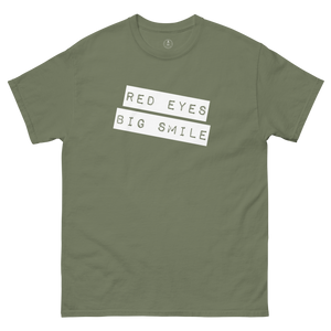 Wrinkled army green Covert Grin Tee, capturing the lived-in look of an agent's favorite go-to piece.
