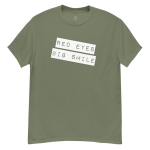 Wrinkled army green Covert Grin Tee, capturing the lived-in look of an agent's favorite go-to piece.