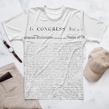 Load image into Gallery viewer, Wrinkled Agent Green Thumb&#39;s Constitution All-Over Print T-Shirt, demonstrating its casual and stylish appeal for cannabis enthusiasts, jon a table with watch pants and wallet and baseball hat