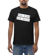 Load image into Gallery viewer, Experience comfort and style with the trendy RED EYES BIG SMILE T-Shirt - Black Shirt Male Model Mockup - RED EYES BIG SMILE: Cozy Weed Clothing for Unmatched Comfort - Streetwear Style: Defeat Villains in Fashion with RED EYES BIG SMILE