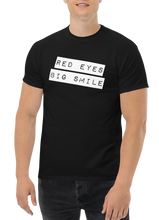 Load image into Gallery viewer, &quot;Make a statement with our RED EYES BIG SMILE Classic Tee - Black T-shirt Male Model Mockup - Funny Weed Shirt: Spread Love and Compassion with RED EYES BIG SMILE Black