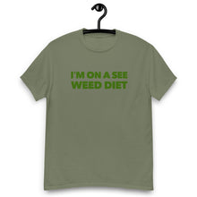 Load image into Gallery viewer, Flat lay of the army green Strains tee, blending the vigor of nature with the mystery of Agent Green Thumb&#39;s mission.