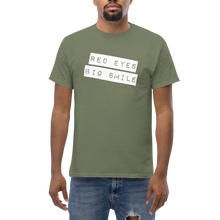 Load image into Gallery viewer, Get noticed with the RED EYES BIG SMILE Tee in 100% cotton - Model Mockup Male Army Green - Funny Weed Shirt: Spread Love and Compassion with RED EYES BIG SMILE Man Model Pose Front