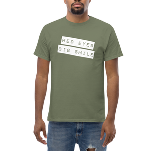 Get noticed with the RED EYES BIG SMILE Tee in 100% cotton - Model Mockup Male Army Green - Funny Weed Shirt: Spread Love and Compassion with RED EYES BIG SMILE Man Model Pose Front