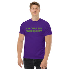 Load image into Gallery viewer, Model stands enigmatically in the purple Strains tee, a shadowy figure in the world of secret style operatives.